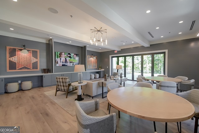 dining room with beam ceiling and light hardwood / wood-style flooring