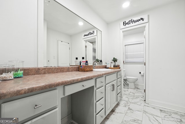 bathroom featuring vanity and toilet