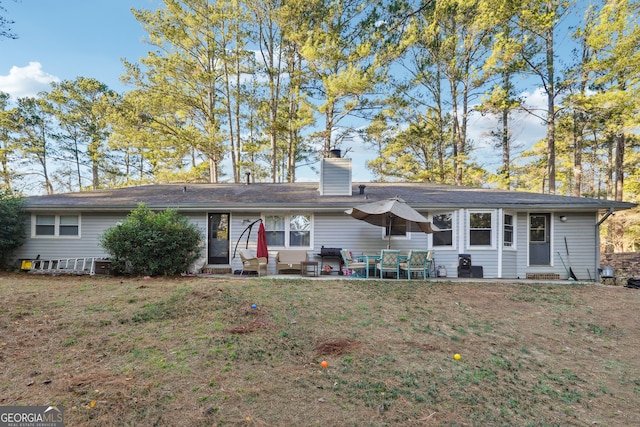 rear view of house with an outdoor living space and a patio area