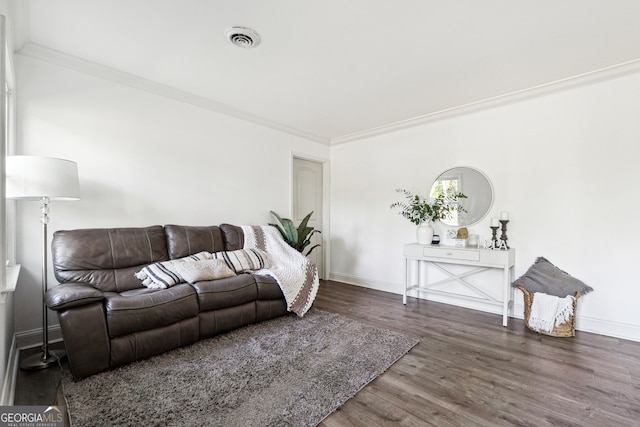 living room with dark hardwood / wood-style flooring and crown molding