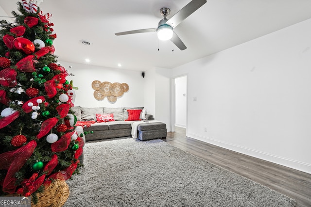 living room with hardwood / wood-style flooring and ceiling fan