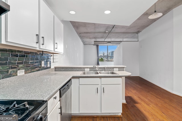 kitchen featuring under cabinet range hood, a peninsula, a sink, dishwasher, and dark wood finished floors