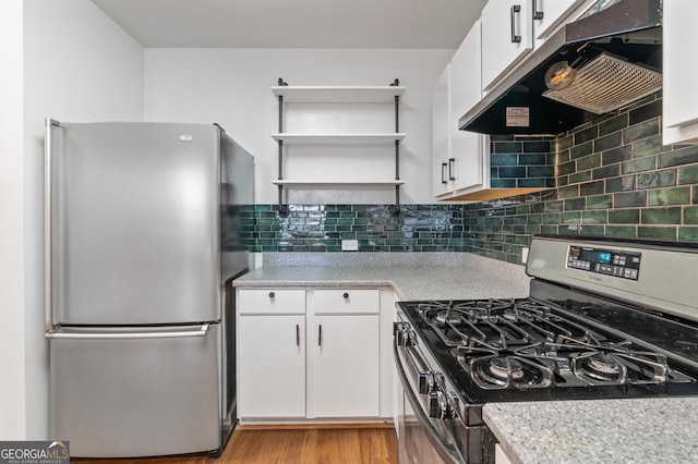 kitchen featuring stainless steel appliances, white cabinetry, under cabinet range hood, and open shelves