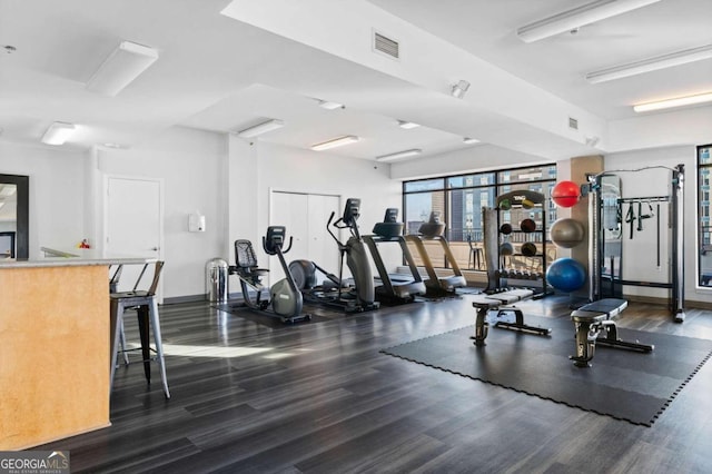 exercise room with visible vents and wood finished floors