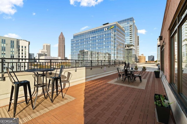 view of patio featuring a view of city and a balcony