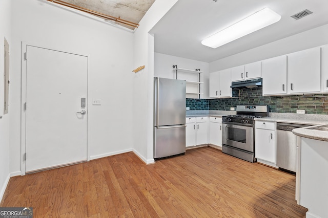 kitchen featuring appliances with stainless steel finishes, light wood-type flooring, visible vents, and under cabinet range hood