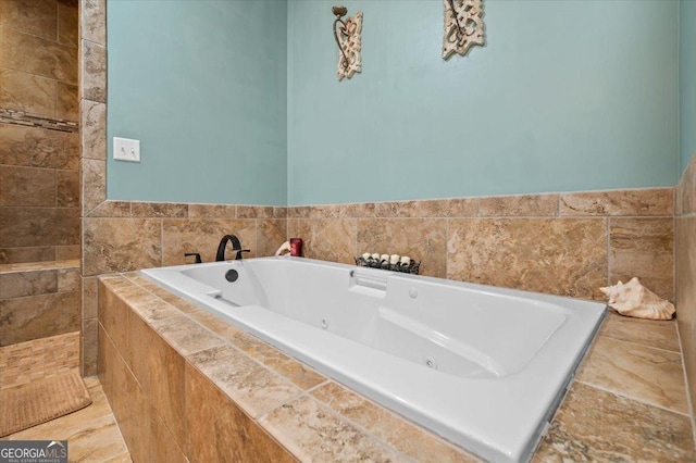 bathroom featuring tiled tub