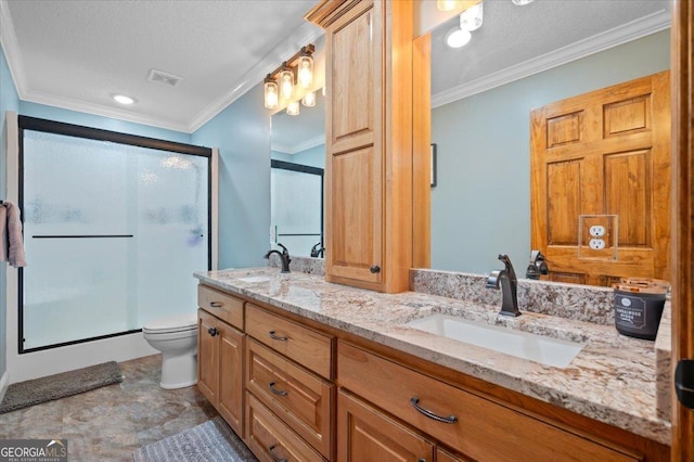 bathroom featuring vanity, toilet, a shower with shower door, and crown molding