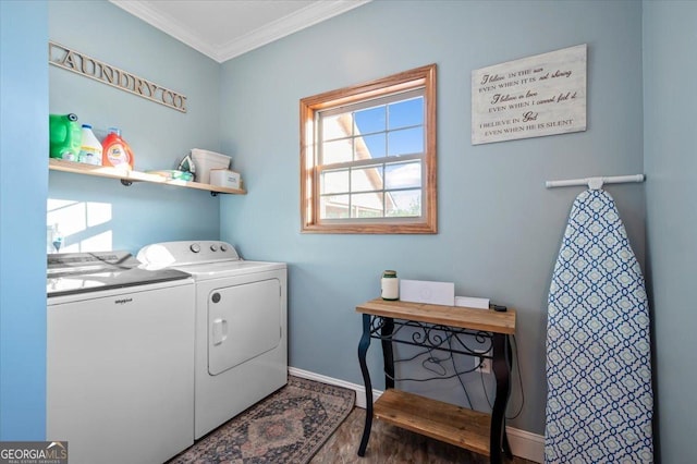 laundry room with washing machine and clothes dryer, hardwood / wood-style flooring, and ornamental molding