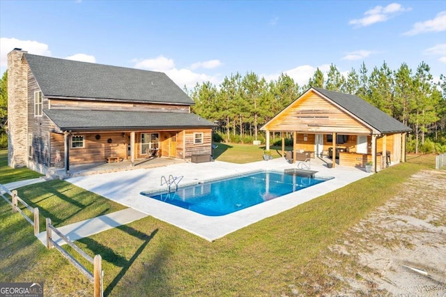 view of pool featuring a lawn and a patio area