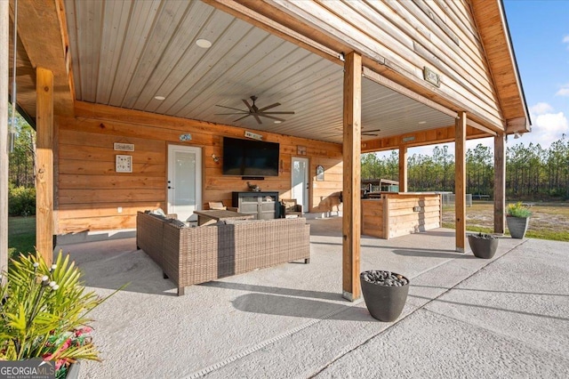 view of patio / terrace featuring outdoor lounge area, ceiling fan, and an outdoor kitchen