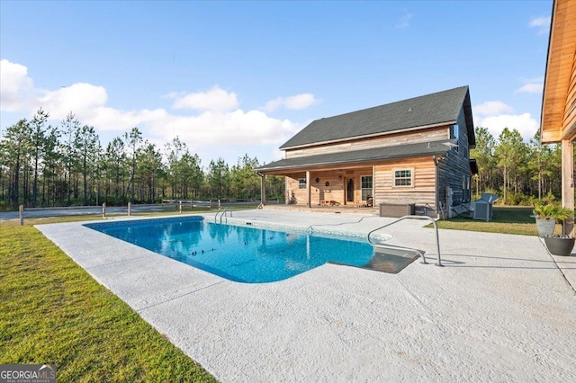 view of swimming pool with a patio and central AC unit