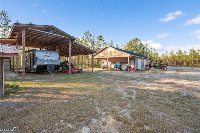 view of yard featuring an outdoor structure and a carport