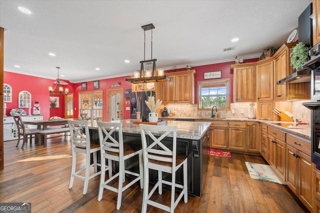 kitchen with stainless steel fridge with ice dispenser, dark hardwood / wood-style flooring, decorative light fixtures, and a kitchen island