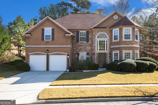 view of front property featuring a garage and a front yard