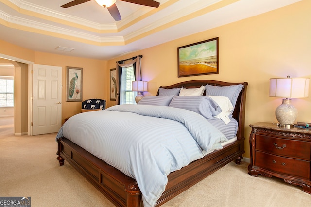 bedroom with light colored carpet, ceiling fan, and crown molding