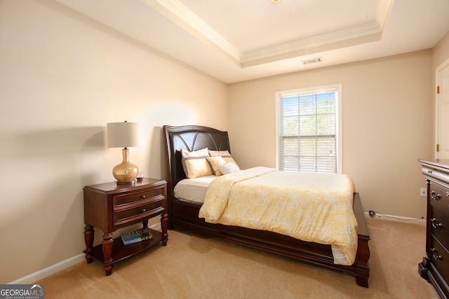 carpeted bedroom with a raised ceiling and ornamental molding