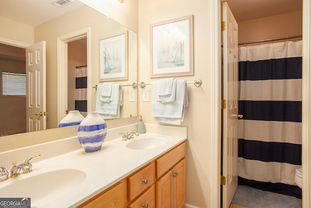 bathroom with vanity, a shower with shower curtain, and toilet