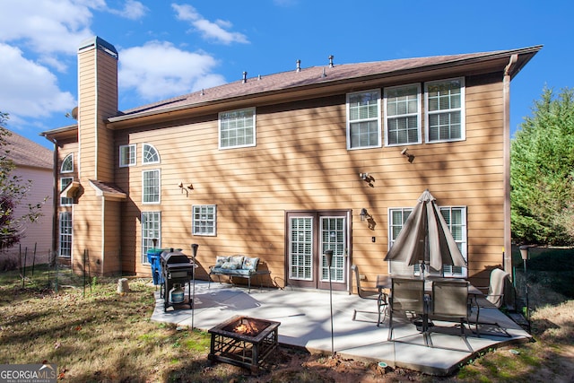 back of house with a patio and an outdoor fire pit