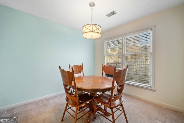 dining space featuring carpet floors