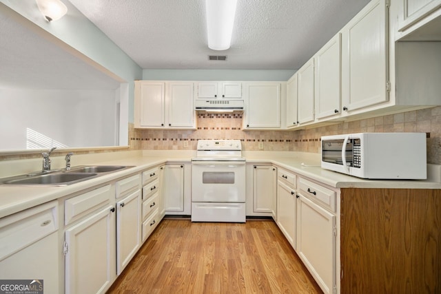 kitchen featuring a textured ceiling, white appliances, sink, light hardwood / wood-style floors, and white cabinetry