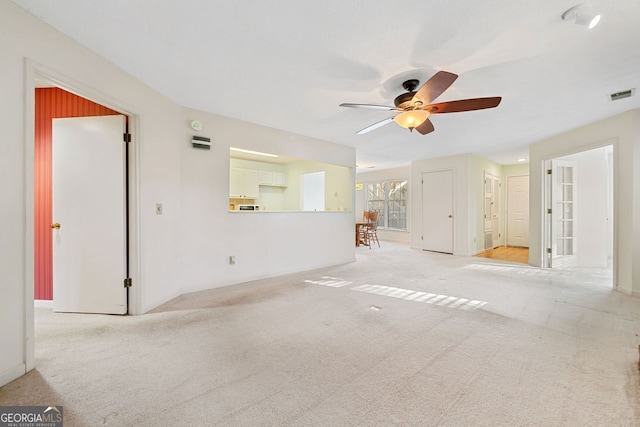 1115 Cannongate Xing SW, Marietta, GA 30064 - unfurnished living room featuring a ceiling fan and light carpet