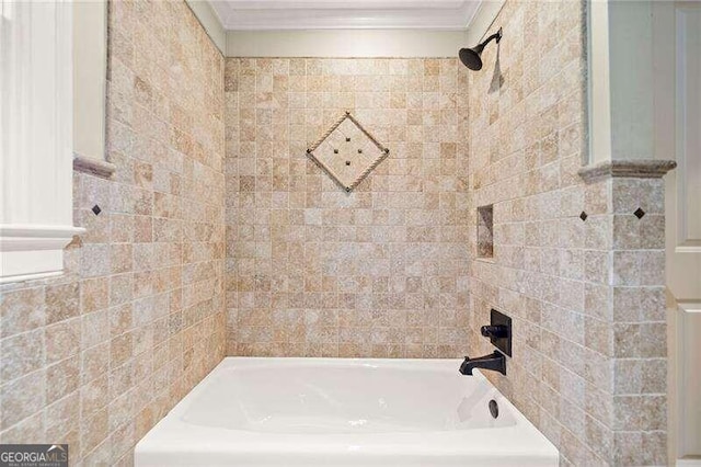 bathroom featuring tiled shower / bath combo and crown molding