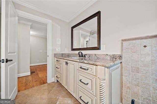 bathroom featuring hardwood / wood-style floors, vanity, and ornamental molding