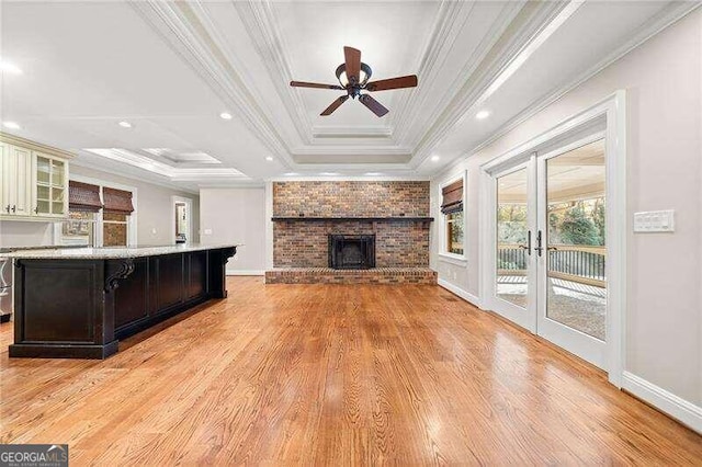 unfurnished living room featuring french doors, crown molding, and light hardwood / wood-style flooring