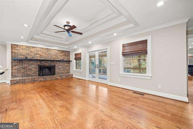 unfurnished living room with ceiling fan, light wood-type flooring, and ornamental molding