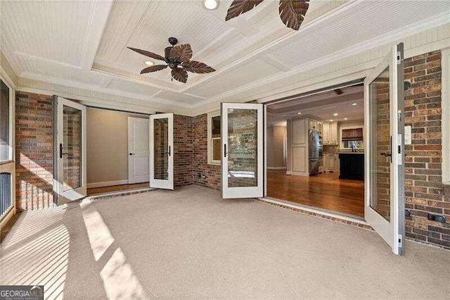 unfurnished sunroom featuring ceiling fan, french doors, and coffered ceiling