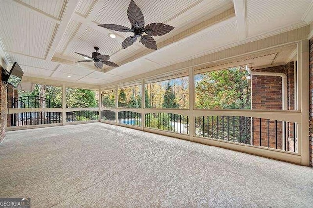 unfurnished sunroom with ceiling fan, a wealth of natural light, and coffered ceiling