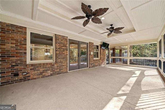 unfurnished sunroom with ceiling fan and coffered ceiling