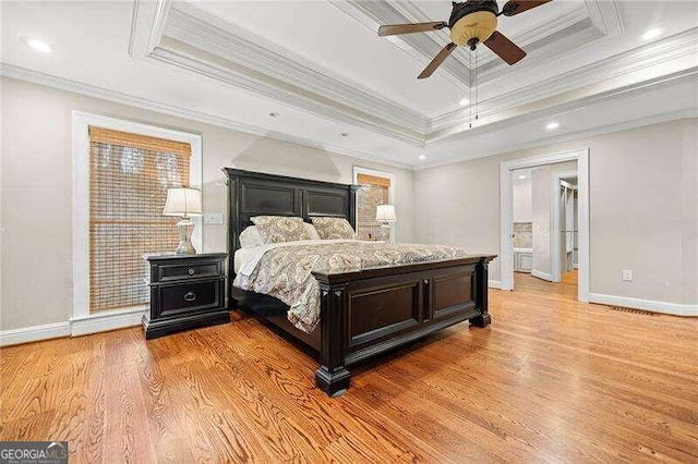 bedroom with a raised ceiling, ceiling fan, light hardwood / wood-style flooring, and ornamental molding