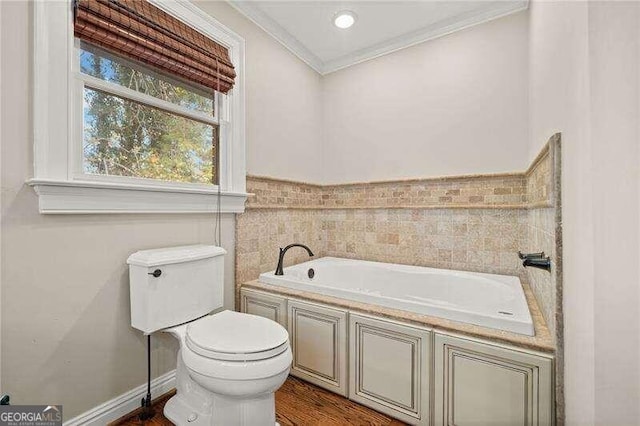 bathroom with a bathing tub, crown molding, toilet, tile walls, and hardwood / wood-style flooring