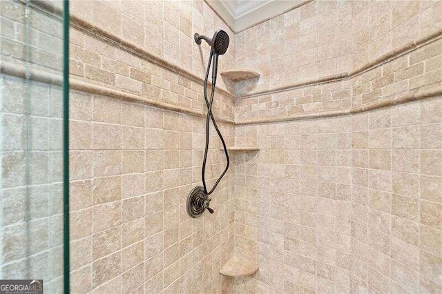 interior details featuring a tile shower