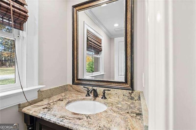 bathroom featuring vanity and ornamental molding