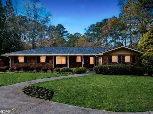 ranch-style home featuring a front yard