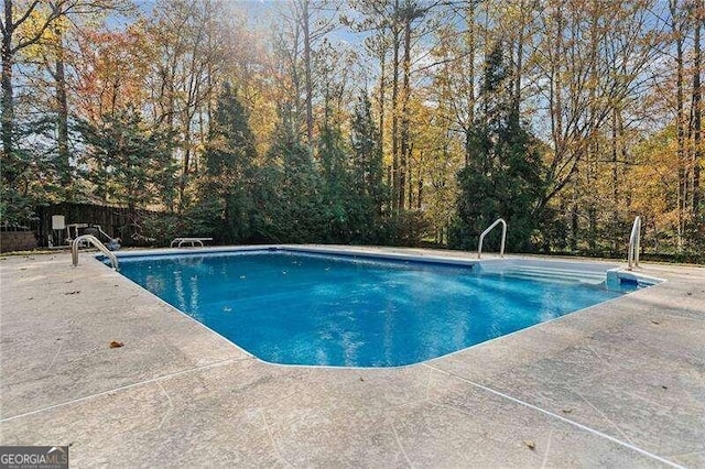 view of swimming pool with a patio