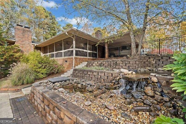 back of house with a sunroom