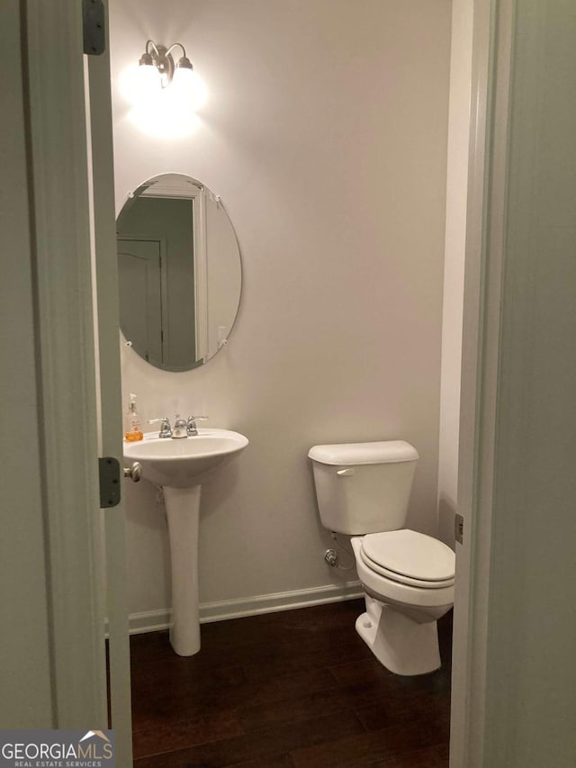 bathroom featuring sink, hardwood / wood-style floors, and toilet