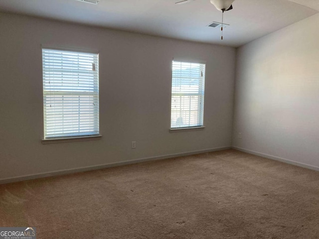 unfurnished room with carpet and ceiling fan