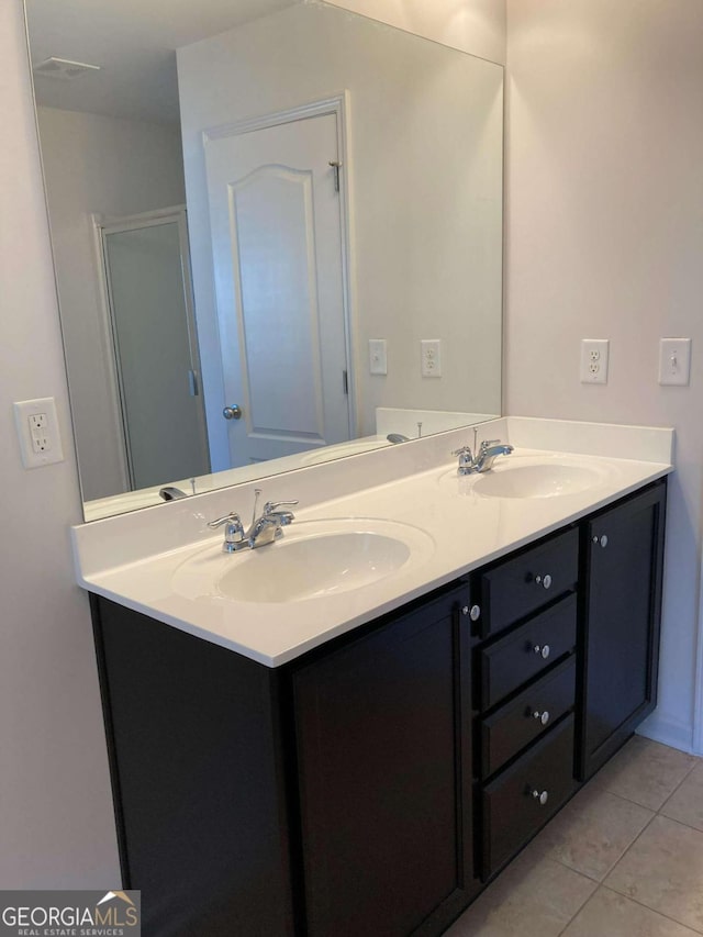 bathroom featuring tile patterned flooring and vanity