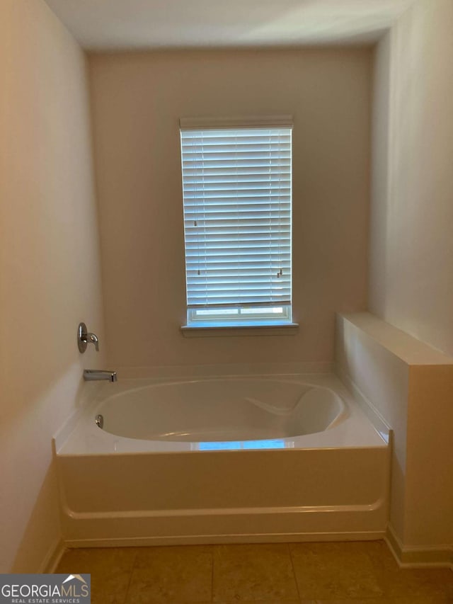 bathroom featuring a bathing tub and tile patterned flooring