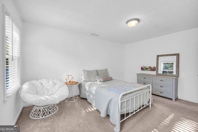 bedroom with light colored carpet