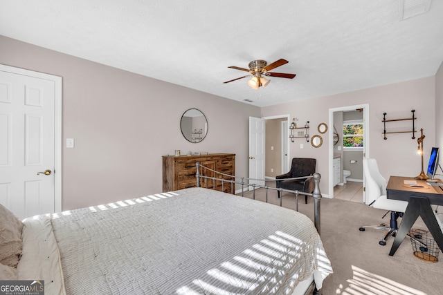 carpeted bedroom with connected bathroom and ceiling fan