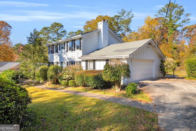 view of side of property with a lawn and a garage