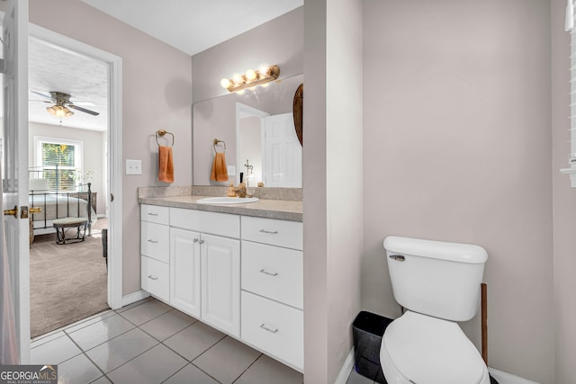 bathroom featuring tile patterned flooring, vanity, toilet, and ceiling fan