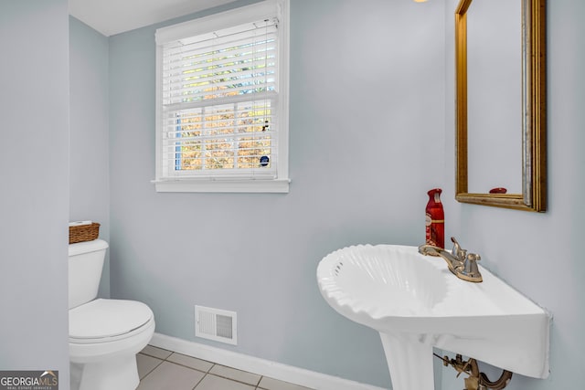 bathroom with tile patterned flooring, toilet, and sink