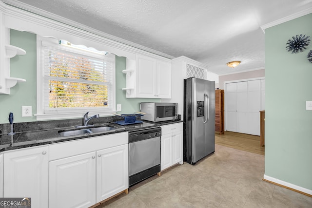 kitchen with a textured ceiling, white cabinetry, sink, and appliances with stainless steel finishes